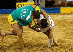 Two sportsmen taking part in Canarian wrestling in a ‘terrero’ ring