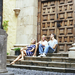 A group of youngsters sitting and chatting on some stone steps