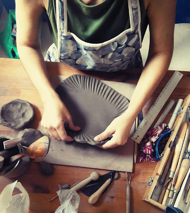 A craftswoman working in her crafts workshop