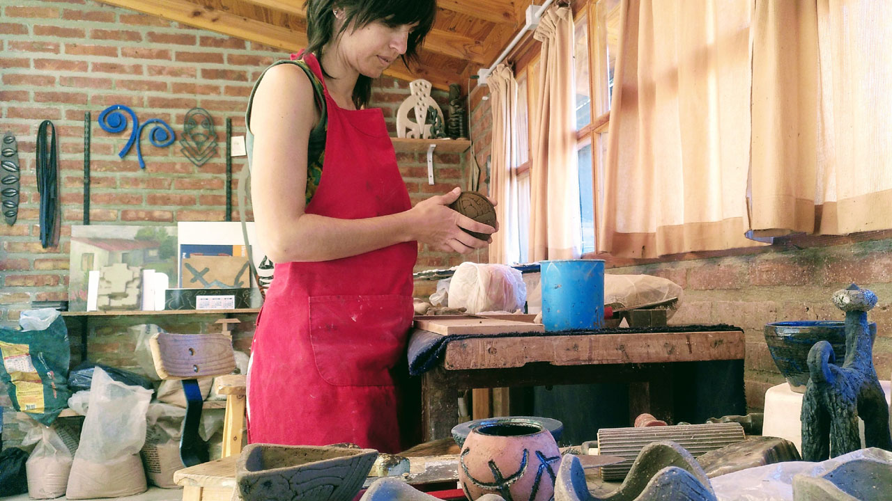 A craftswoman working in her crafts workshop