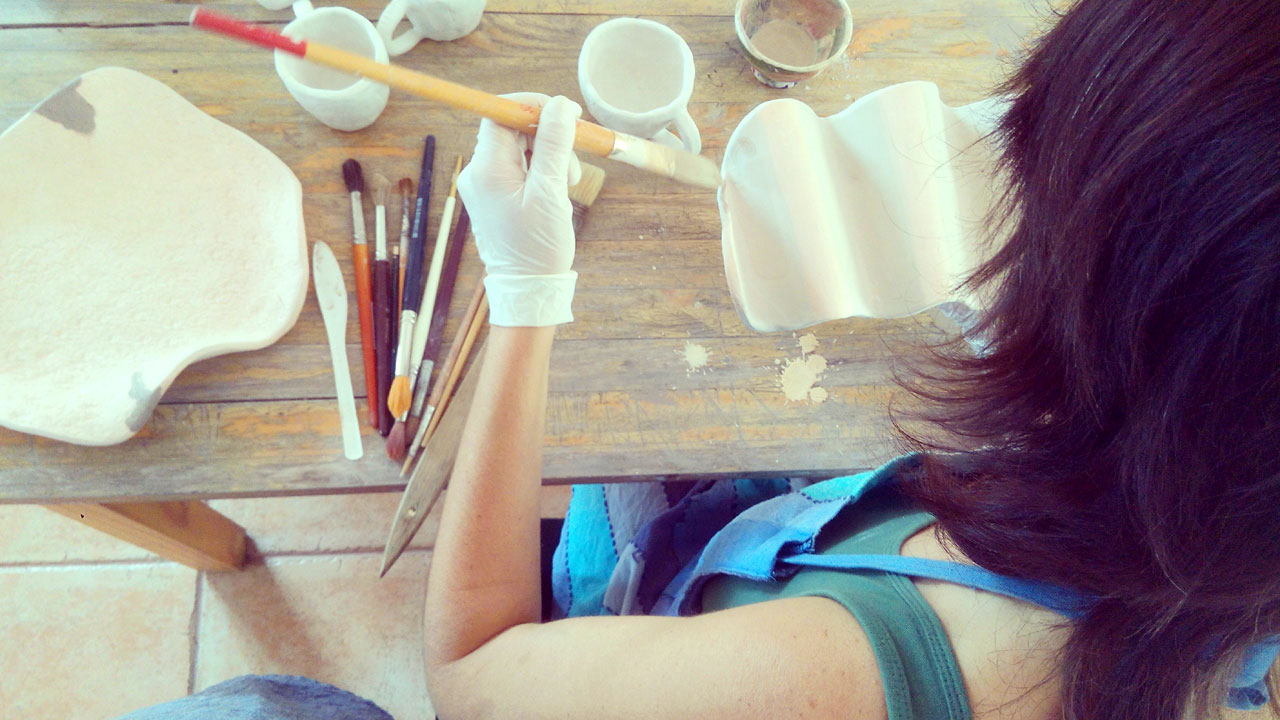 A craftswoman working in her crafts workshop