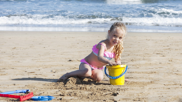 A girl playing in Maspalomas beach, Gran Canaria