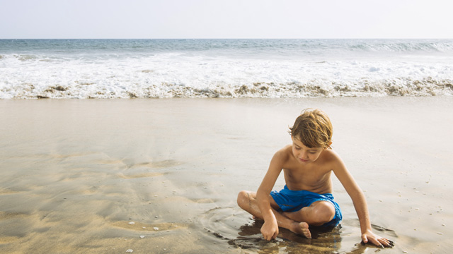 A child playing in Maspalomas beach, Gran Canaria