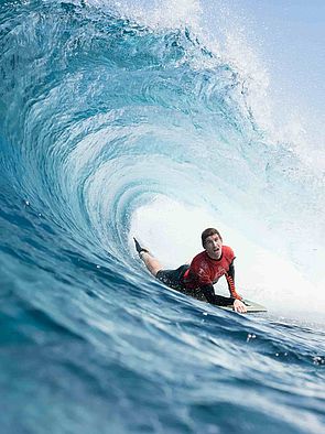 Young man catches a wave in Gran Canaria