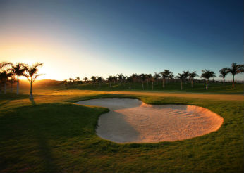 A player aiming for the green at Meloneras Golf