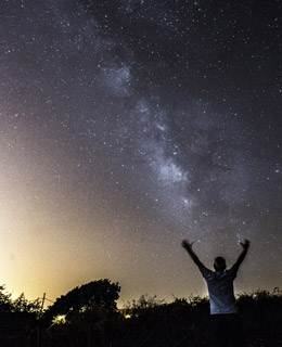 A hiker under a starry sky