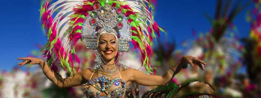 Carnival girl in fancy dress dancing in the streets