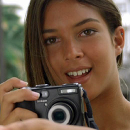 A girl taking a photo of other children in the Plaza de Santa Ana square