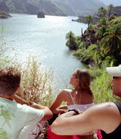 Young people looking out over the Presa de la Sorrueda reservoir