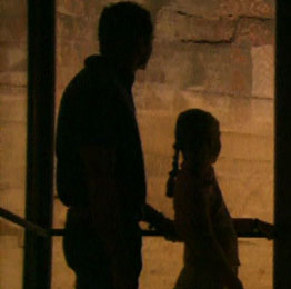 A family observing the paintings at the Cueva Pintada in Gáldar