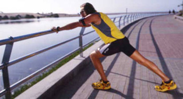 A runner stretching at Maspalomas