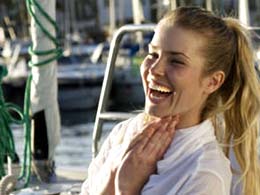 A girl laughing on the mole at Mogán