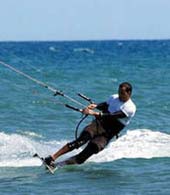 A kitesurfer flying through the air on his board