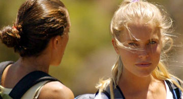 Close up of girl with another girl with her back to us