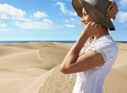 A girl smiling next to the Maspalomas dunes